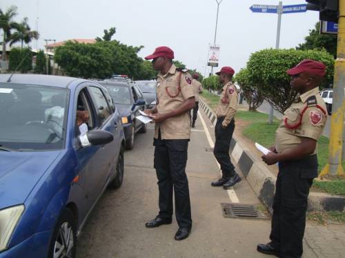 FRSC officials check a vehicle and driver on the road